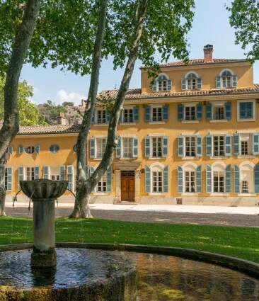 Château d’Esclans estate building with fountain and trees in a Provence garden setting