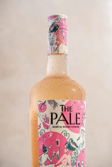 The Pale rosé bottle close-up showing illustrated label and fresh condensation