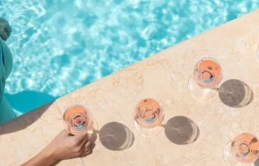 Travel Daily Media article featuring Whispering Angel at The Nomad Garden in Dubai, highlighting a luxury desert dining experience combining lifestyle, gastronomy, and sunset moments.